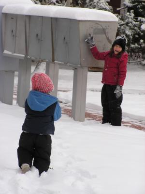 Noah follows Andrea through the snow to the mail boxes.