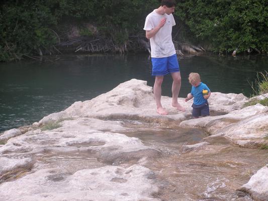 David and Noah on top of the falls.
Noah plays in the pools.