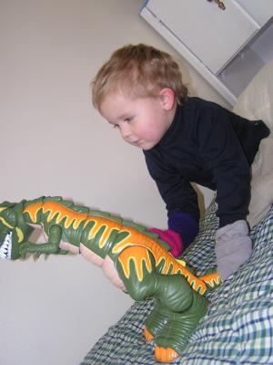 Noah plays with a  dinosaur