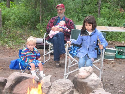 Noah, Robert, Sarah, Malia sit by the campfire.