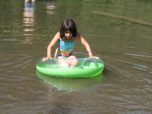 Malia tries to stay on top of the green innertube.