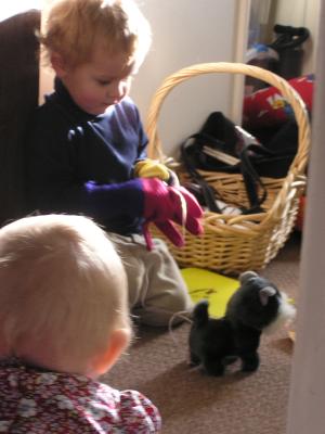 Noah and Sarah play with the toy dog.