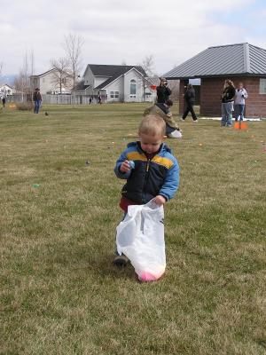 Noah gathers eggs at the GVCC Easter egg hunt.