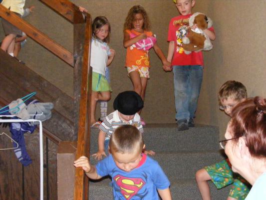 Preschoolers coming down the stairs. 
