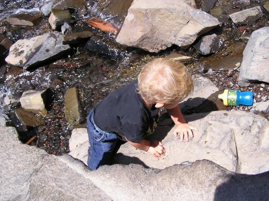 Noah plays on the rocks.