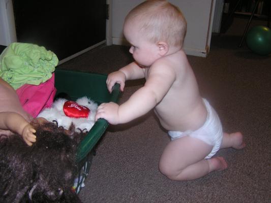 Sarah looks into the toy basket.