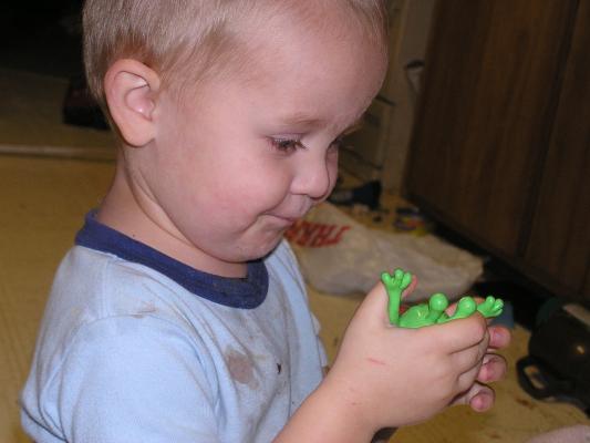 Noah plays with an alien toy.