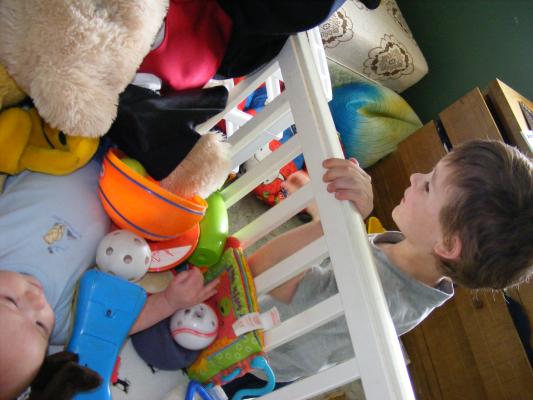 Noah got all the baby toys for Joshua to play with.