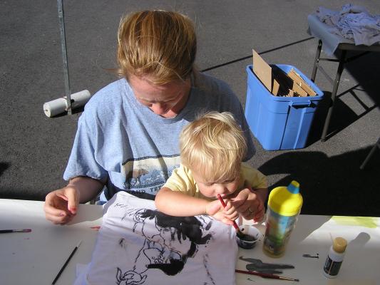 Katie and Noah paint a shirt.