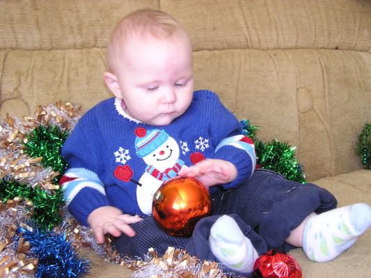 Sarah plays with Christmas balls.