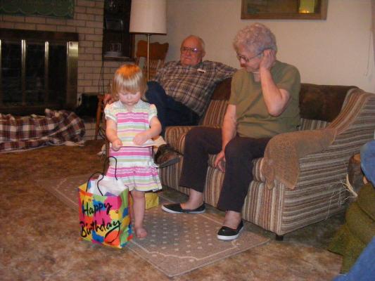 Sarah is about to open a gift from Great Grandpa and Great Grandpa