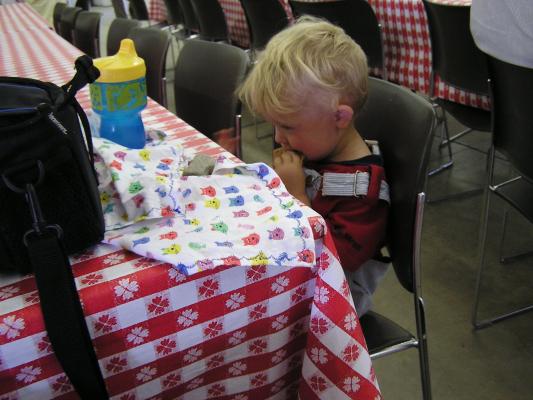 Noah eats some lunch at the fair.
