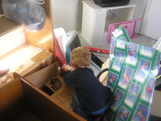 Noah climbs over boxes in our new mobile home