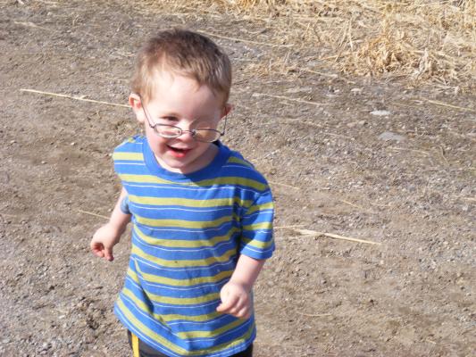 Noah runs and plays. He has his eye patch on.