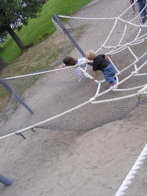 Noah and Andrea play in the spider web.