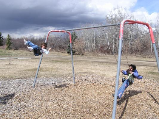 Andrea and Malia swing at East Gallatin Recreation Area.