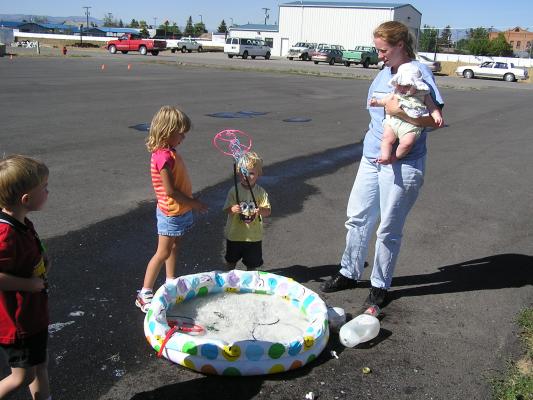 Ty, Mickala, and Noah make bubbles at the VBS carnival bubble pond.
