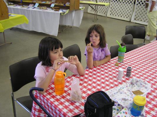 Malia and Andrea eat some lunch at the county fair.