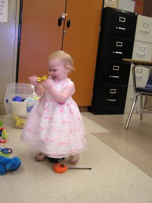Sarah plays with toys in the nursery.