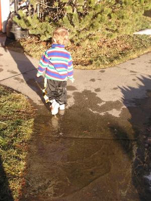 Noah plays in puddles.