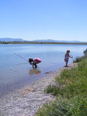 Andrea fishing while Sarah plays.