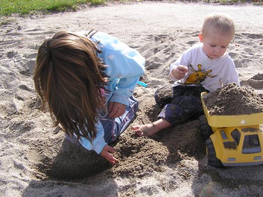 Noah and Andrea play in the sand