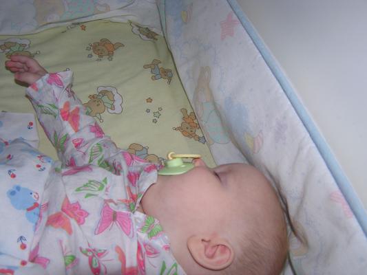 Sarah sleeps in her crib.