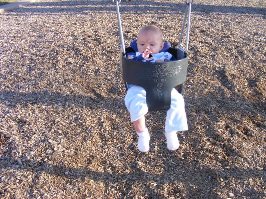 Joshua's first time in a park swing.