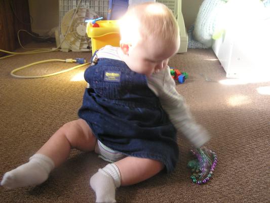 Sarah plays with some mardigras beads.