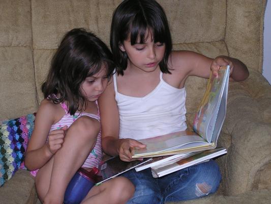 Andrea and Malia read a story.