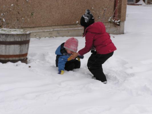 Andrea helps Noah brush off the snow.