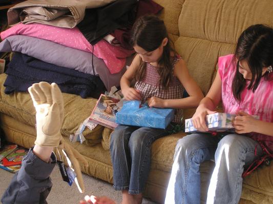 Andrea and Malia open gifts. Looks like someone got gloves