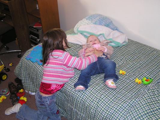 Andrea tickels Sarah on Noah's new bed.