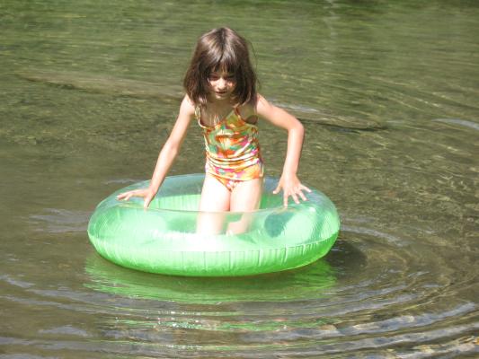 Andrea on a green floaty thing.
