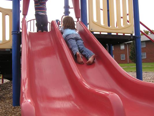 playing on the slide at the park.