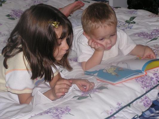 Andrea and Noah read a book together.