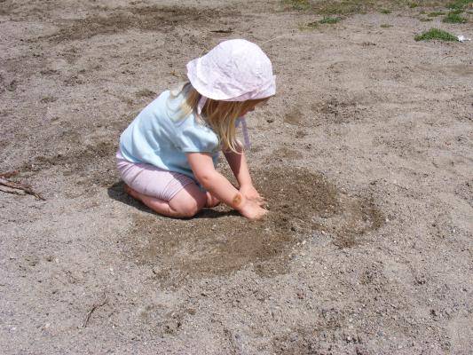 Sarah digs in the sand at Bozeman Pond.
