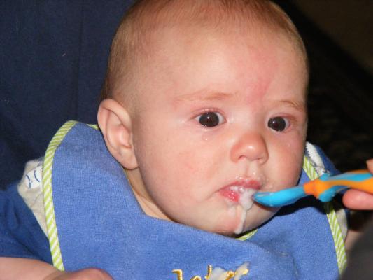 Joshua eats rice cereal