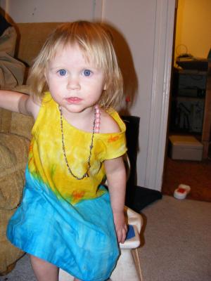 Sarah in a bright yellow dress and pretty necklaces.