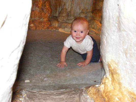 Joshua is happy to crawl through a cave.