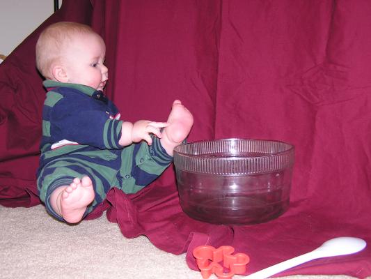 Noah plays with a mixing bowl.