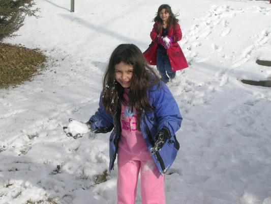 Malia and Andrea make snow balls.