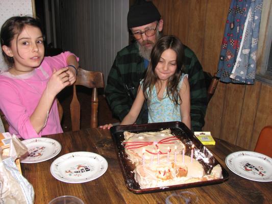 Malia and Grandpa watch Andrea get ready to blow otu candles.