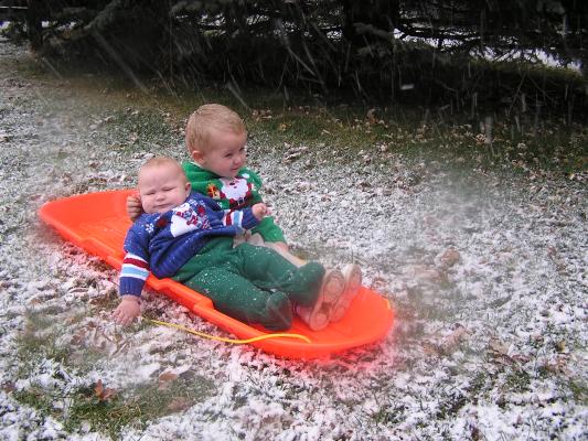 Sarah and Noah get pictures on a sled.