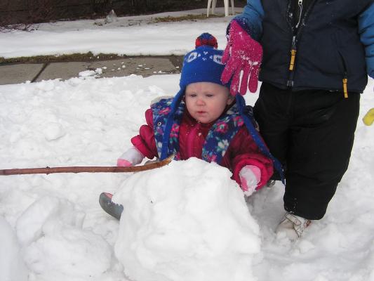 Sarah and Noah are building a snowman.