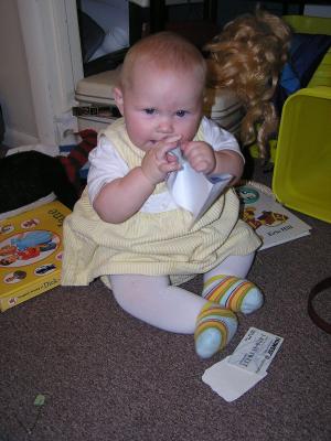 Sarah, in a yellow jumper, eating paper