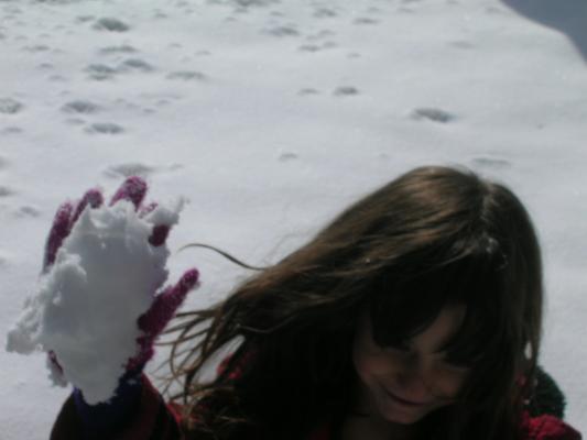 Andrea throws a snow ball.