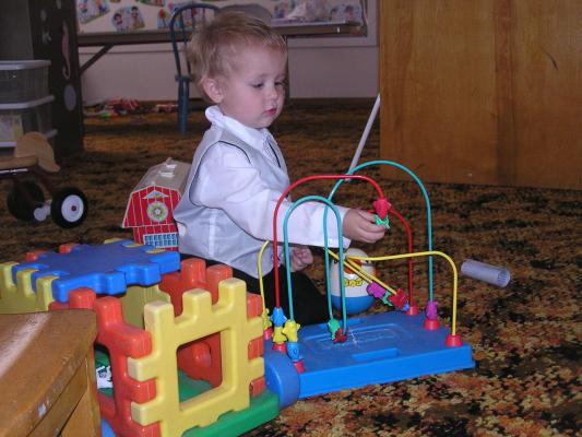 Noah plays toys in the church nursery