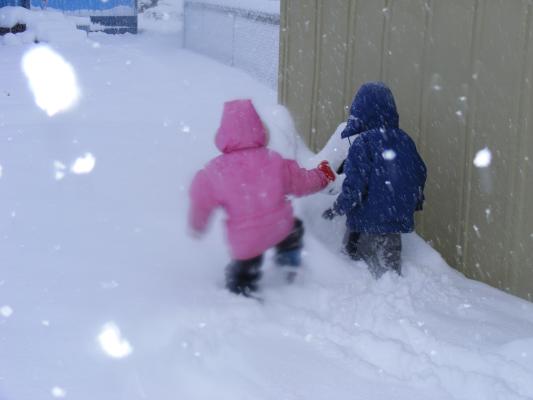 Sarah and Noah walk through deep snow.