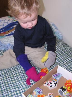 Noah plays wiht magnetic animals.